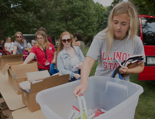 Students collecting school supplies on the quad.