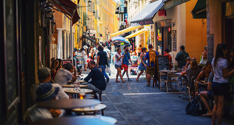 Street lined with shops and cafes in Nice, France.