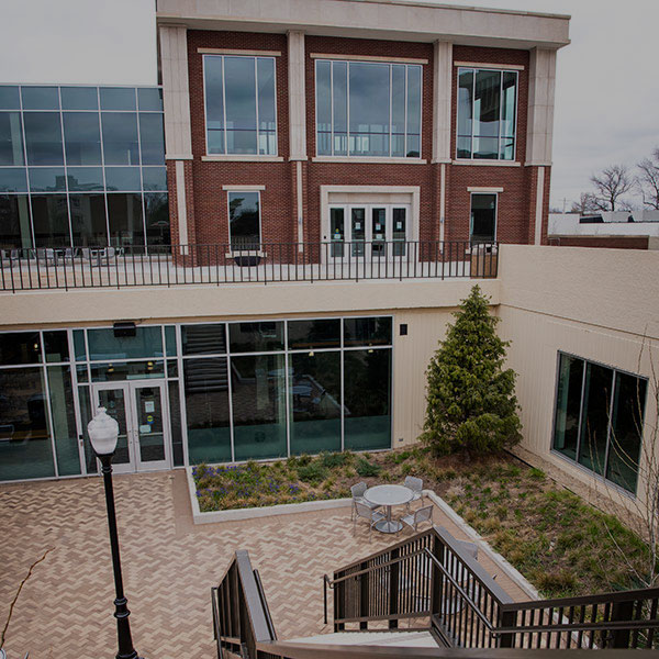 Lower courtyard with trees and upper building at the Bone Student Center.